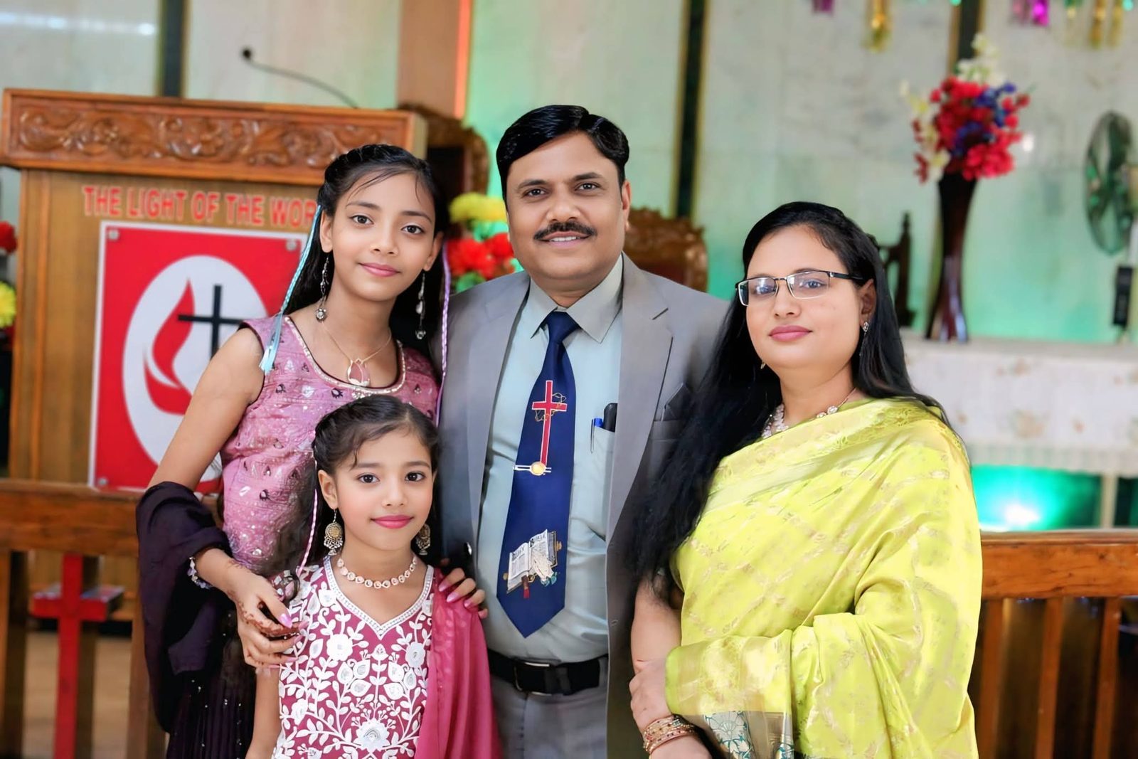 The pastor with his family in the church
